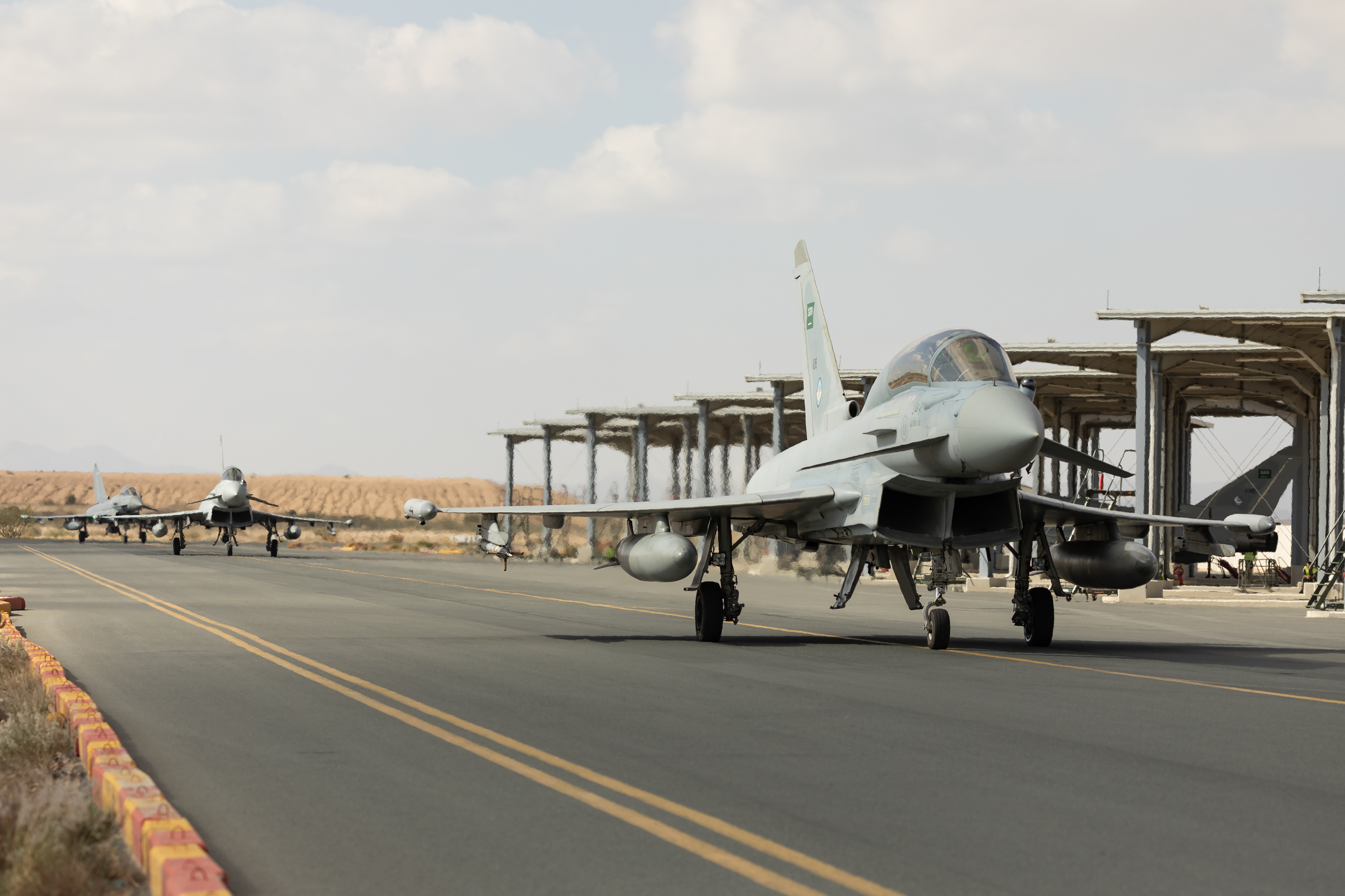 Image shows three RAF Typhoons taxiing on the airfield.